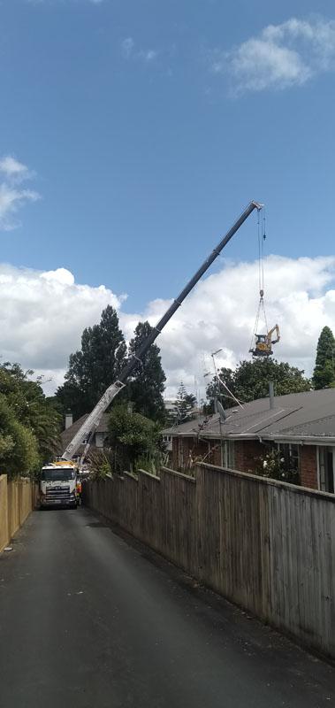residential-crane-excavator-drill-rig-over-house.jpg